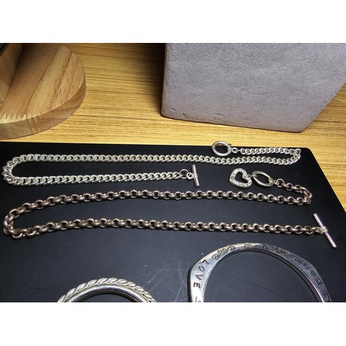 325 - A large collection of various silver plated items which includes 2 good pocketwatch chains, a curb l... 