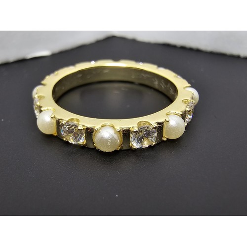 201 - A pretty gold plate on 925 silver eternity ring featuring faux pearls and cz crystal stones all the ... 