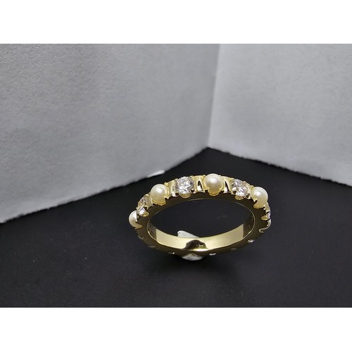 201 - A pretty gold plate on 925 silver eternity ring featuring faux pearls and cz crystal stones all the ... 