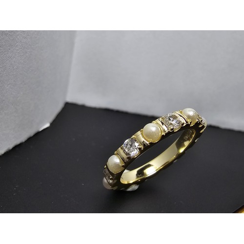 201 - A pretty gold plate on 925 silver eternity ring featuring faux pearls and cz crystal stones all the ... 