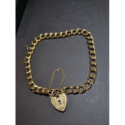 203 - A gold plated 925 sterling silver bracelet with a sterling silver padlock clasp with safety chain, i... 