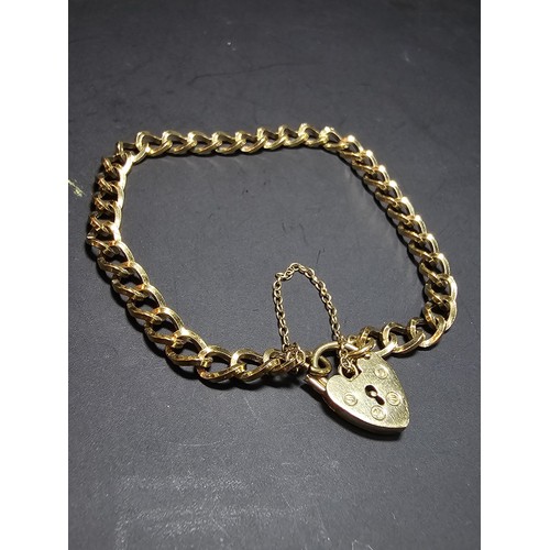 203 - A gold plated 925 sterling silver bracelet with a sterling silver padlock clasp with safety chain, i... 