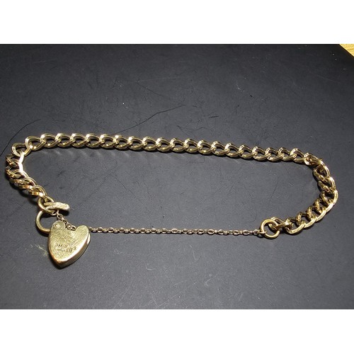 203 - A gold plated 925 sterling silver bracelet with a sterling silver padlock clasp with safety chain, i... 