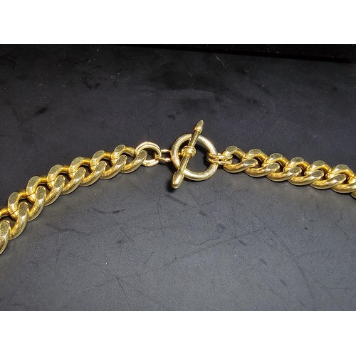 202 - A large unused heavy duty gold plated curb link neck chain with a bar and T clasp along with an 18ct... 