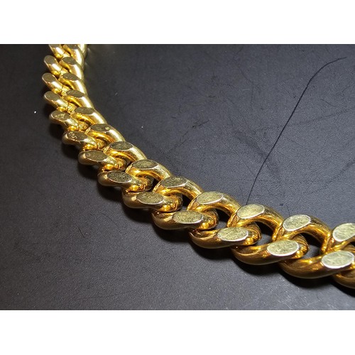 202 - A large unused heavy duty gold plated curb link neck chain with a bar and T clasp along with an 18ct... 