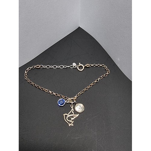 212 - A pretty 925 silver bracelet with 3 silver charm drops which includes a bird charm, a blue crystal c... 