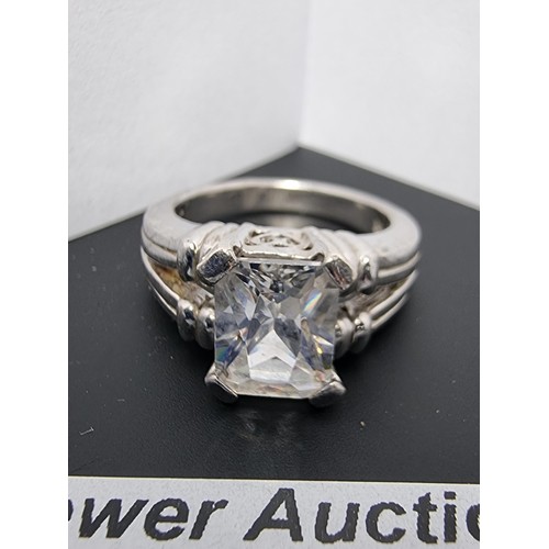 214 - A good quality ornate 925 silver dress ring inset with a large faceted rectangular cz crystal stone ... 