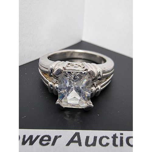 214 - A good quality ornate 925 silver dress ring inset with a large faceted rectangular cz crystal stone ... 