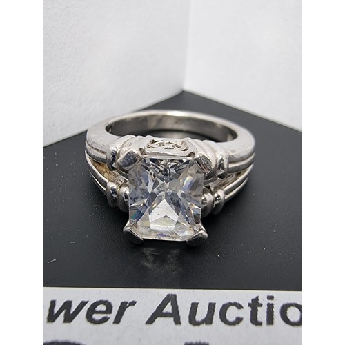 214 - A good quality ornate 925 silver dress ring inset with a large faceted rectangular cz crystal stone ... 