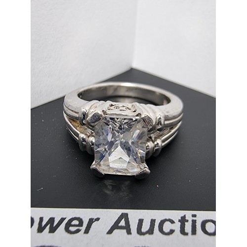 214 - A good quality ornate 925 silver dress ring inset with a large faceted rectangular cz crystal stone ... 