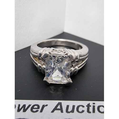 214 - A good quality ornate 925 silver dress ring inset with a large faceted rectangular cz crystal stone ... 