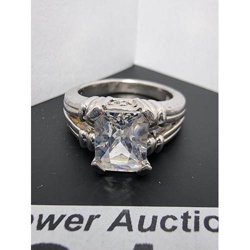 214 - A good quality ornate 925 silver dress ring inset with a large faceted rectangular cz crystal stone ... 