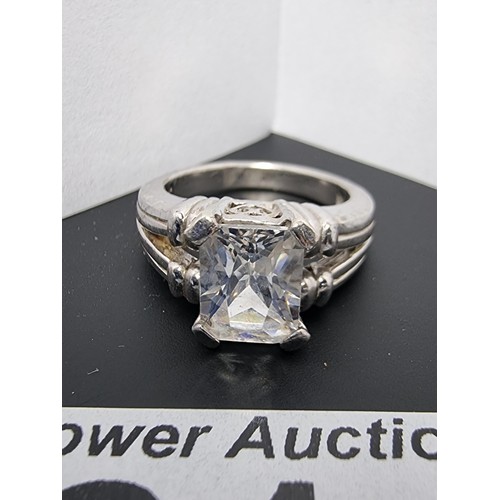 214 - A good quality ornate 925 silver dress ring inset with a large faceted rectangular cz crystal stone ... 