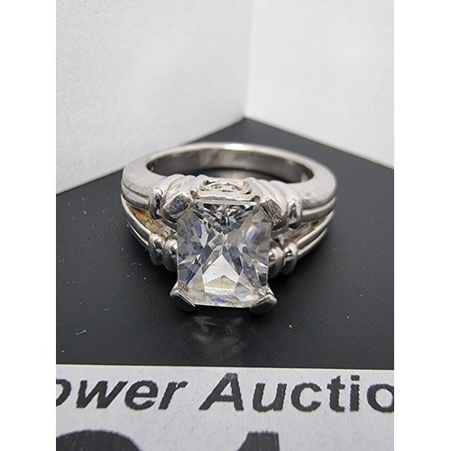 214 - A good quality ornate 925 silver dress ring inset with a large faceted rectangular cz crystal stone ... 