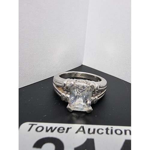 214 - A good quality ornate 925 silver dress ring inset with a large faceted rectangular cz crystal stone ... 