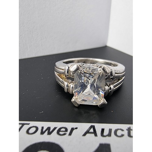 214 - A good quality ornate 925 silver dress ring inset with a large faceted rectangular cz crystal stone ... 