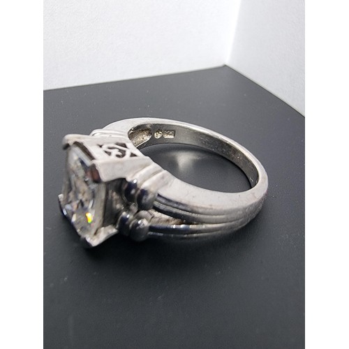 214 - A good quality ornate 925 silver dress ring inset with a large faceted rectangular cz crystal stone ... 