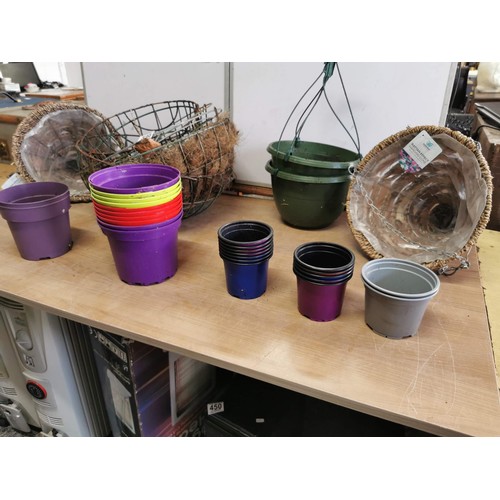 361 - A selection of 8+ hanging baskets along with a selection of coloured flower pots. Also included are ... 