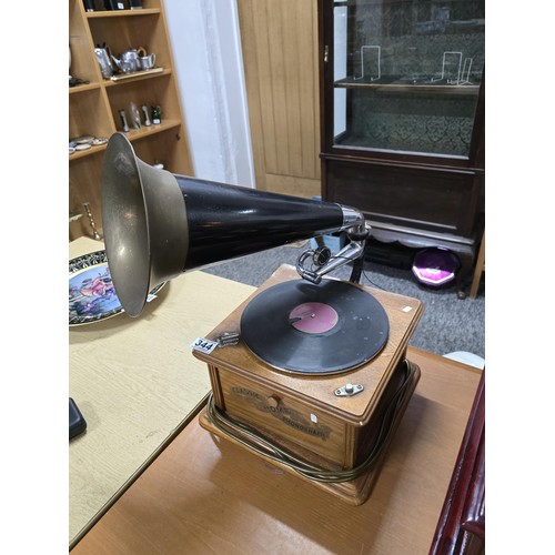 344 - An attractive reproduction classic home phonograph with a large brass horn the music player features... 