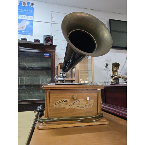 344 - An attractive reproduction classic home phonograph with a large brass horn the music player features... 