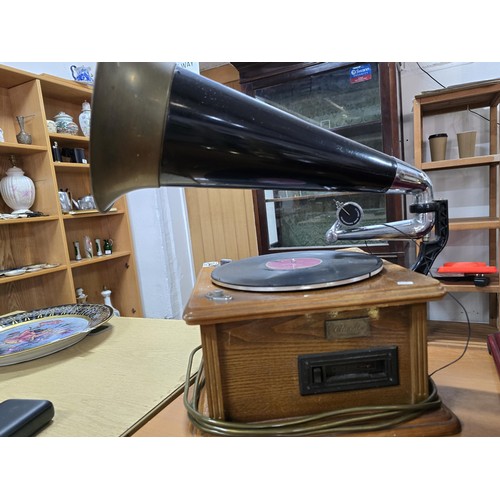 344 - An attractive reproduction classic home phonograph with a large brass horn the music player features... 