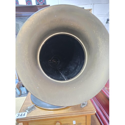 344 - An attractive reproduction classic home phonograph with a large brass horn the music player features... 