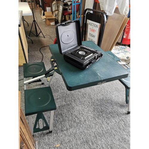 352 - Vintage camp bed with a plastic folding picnic table and cased portable gas stove