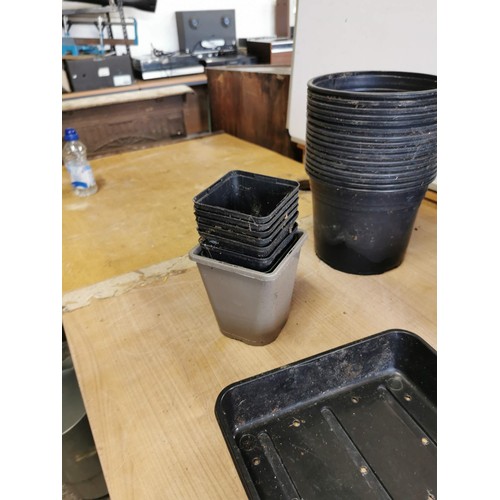 363 - Crate containing a large quantity of plastic garden pots of various sizes along with trays