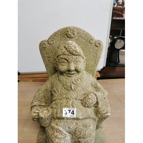 374 - Large heavy concrete garden ornament of a Gnome drinking sitting on a chair, in good overall conditi... 