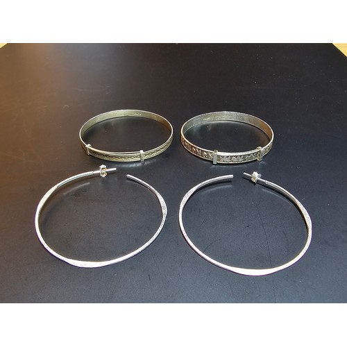 225 - 2 x Sterling silver Christening bangles along with a pair of 925 brushed silver large hoop earrings ... 