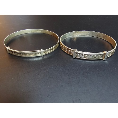 225 - 2 x Sterling silver Christening bangles along with a pair of 925 brushed silver large hoop earrings ... 