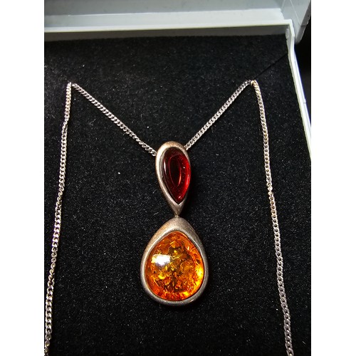 230 - Vintage 925 silver pendant inset with two types of natural amber which is orange and red set on a 18... 