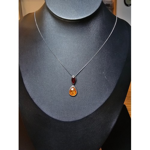 230 - Vintage 925 silver pendant inset with two types of natural amber which is orange and red set on a 18... 