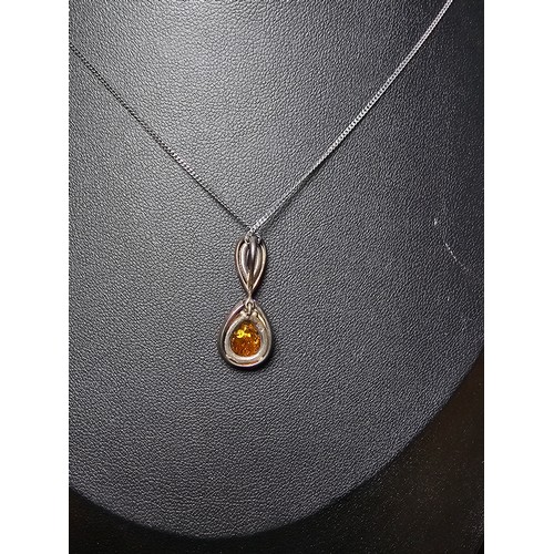 230 - Vintage 925 silver pendant inset with two types of natural amber which is orange and red set on a 18... 