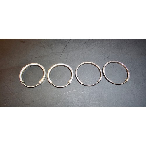 233 - Two pairs of 925 silver hoop earrings of a similar style one pair shinny the other retains its patin... 