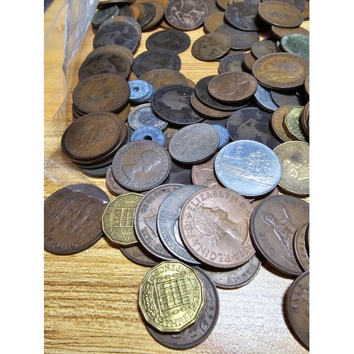 267 - A large bag of various coins which mostly consists of British copper coins along with some world coi... 