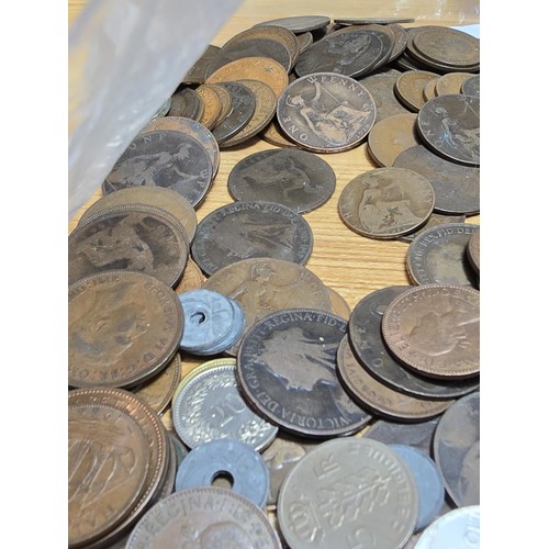 267 - A large bag of various coins which mostly consists of British copper coins along with some world coi... 