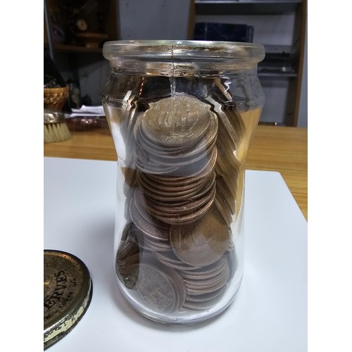 268 - A glass jar full of various British copper coins.