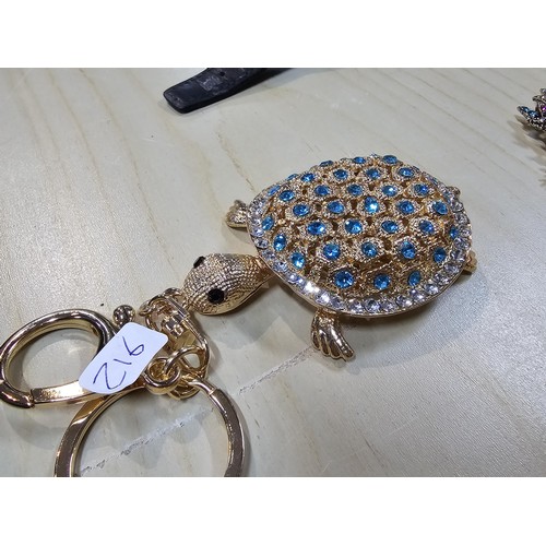 318 - A collection of 5x large ornate jewelled keyrings to include a parrot, dragon and peacock keyring, e... 