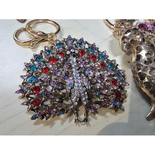 318 - A collection of 5x large ornate jewelled keyrings to include a parrot, dragon and peacock keyring, e... 