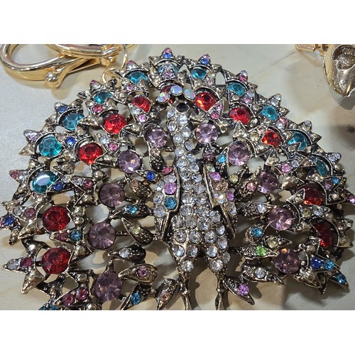 318 - A collection of 5x large ornate jewelled keyrings to include a parrot, dragon and peacock keyring, e... 