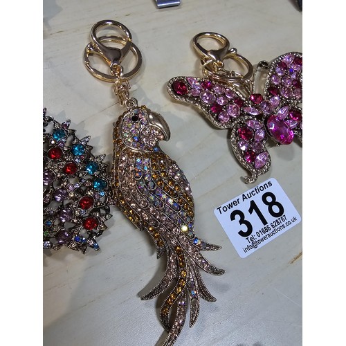 318 - A collection of 5x large ornate jewelled keyrings to include a parrot, dragon and peacock keyring, e... 