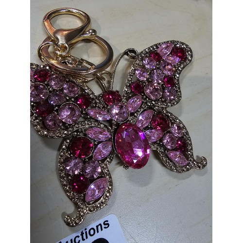 318 - A collection of 5x large ornate jewelled keyrings to include a parrot, dragon and peacock keyring, e... 