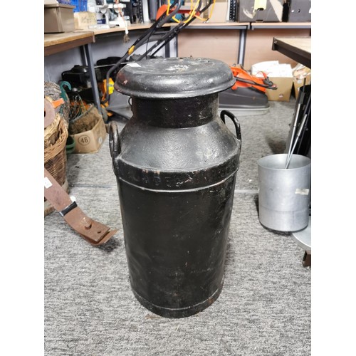 411 - Vintage metal milk churn painted black complete with lid, lid has hole in the top stands at 77cm hig... 