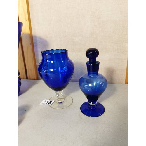 158 - Shelf full of collectable blue glass vases , blue stoppered vase, fluted bowl, etc tallest piece sta... 