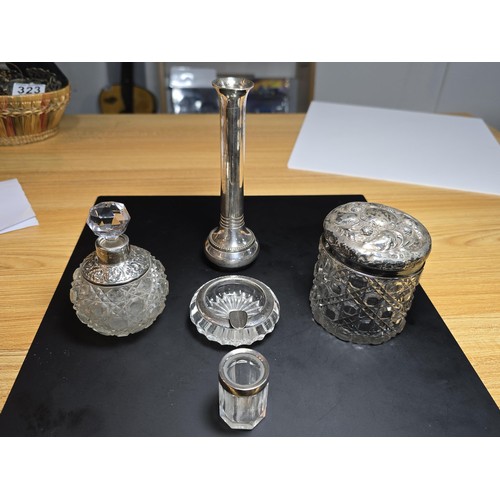 167 - A collection of silver topped crystal items which includes a hallmarked silver topped crystal glass ... 