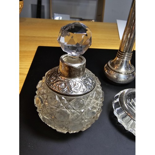 167 - A collection of silver topped crystal items which includes a hallmarked silver topped crystal glass ... 