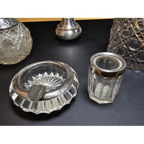 167 - A collection of silver topped crystal items which includes a hallmarked silver topped crystal glass ... 