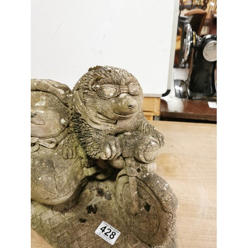 428 - Large stoneware garden ornament of two hedgehogs riding a motorcycle. In good order, stands at 28cm ... 