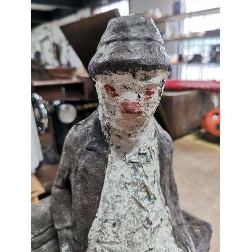 432 - Large garden concrete ornament of a man sitting on a bench, well weathered, stands at 46cm high, 36c... 